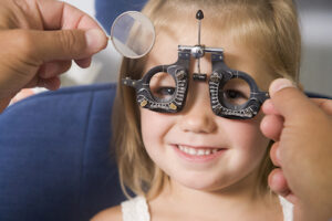 Child getting vision exam by optometrist